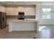 Modern kitchen with white cabinets, stainless steel appliances, and a large island at 6821 Serpent Hawk Lane St, Howey In The Hills, FL 34737