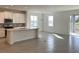 Spacious kitchen featuring a large island, stainless steel appliances, and white cabinets at 6821 Serpent Hawk Lane St, Howey In The Hills, FL 34737
