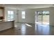 Open concept kitchen with island, stainless steel appliances, and access to backyard at 6821 Serpent Hawk Lane St, Howey In The Hills, FL 34737