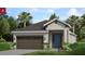 New home exterior with brown garage door and a blue front door at 168 Duckweed Ave, Fruitland Park, FL 34731