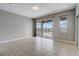 Gathering room with sliding doors leading to a pool and lake view at 8503 Saint Marino Blvd, Orlando, FL 32836