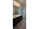 Elegant bathroom with double vanity, large mirror, and spacious shower at 6804 Serpent Hawk Lane St, Howey In The Hills, FL 34737