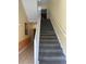 Indoor staircase with carpeted steps and white railings at 1597 Heritage Crossing Ct # 202, Reunion, FL 34747