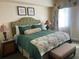 Main bedroom with plush bedding and nightstands at 1597 Heritage Crossing Ct # 202, Reunion, FL 34747