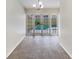 Spacious dining area with French doors leading to a view of the pool at 4934 Samoa Cir # 7, Orlando, FL 32808