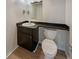 Small bathroom with toilet and dark vanity at 4934 Samoa Cir # 7, Orlando, FL 32808