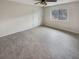Spacious bedroom with ceiling fan and large window at 4934 Samoa Cir # 7, Orlando, FL 32808