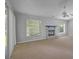 Spacious living room featuring a fireplace and ample natural light at 12337 Greco Dr, Orlando, FL 32824
