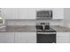 Kitchen boasts granite countertops and stainless steel appliances at 12337 Greco Dr, Orlando, FL 32824
