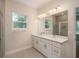 Double vanity bathroom with a large mirror and walk-in shower at 34 Dogwood Dr Crse, Ocala, FL 34472