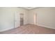 Spacious bedroom with carpeting, door to kitchen, and bathroom access at 34 Dogwood Dr Crse, Ocala, FL 34472