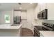 Modern kitchen with stainless steel appliances and white cabinets at 34 Dogwood Dr Crse, Ocala, FL 34472