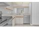 White cabinets and stainless steel appliances in a compact kitchen at 2384 Sun Valley Cir, Winter Park, FL 32792