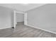 Bedroom with grey walls and wood-look floors, showing access to another room at 2384 Sun Valley Cir, Winter Park, FL 32792
