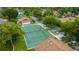 Community tennis court surrounded by lush green trees at 2384 Sun Valley Cir, Winter Park, FL 32792
