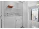 Stackable washer and dryer with shelving in this laundry room at 2384 Sun Valley Cir, Winter Park, FL 32792