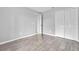 Bedroom with grey walls, wood-look floors, and double door closet at 2384 Sun Valley Cir, Winter Park, FL 32792