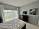 Bright bedroom with water views, dresser, and large bed at 3145 Sun Lake Ct # B, Kissimmee, FL 34747