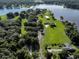 Aerial view of lakefront property with multiple buildings at 16600 Cleveland Ln, Umatilla, FL 32784