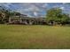 Two story house exterior with large yard and mature trees at 16600 Cleveland Ln, Umatilla, FL 32784