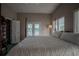 Spacious main bedroom with a walk-in closet and access to a private balcony at 16600 Cleveland Ln, Umatilla, FL 32784