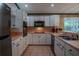 White kitchen with pink countertops and stainless steel appliances at 16600 Cleveland Ln, Umatilla, FL 32784