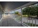 Porch with white railing offering scenic views of a lake and yard at 16600 Cleveland Ln, Umatilla, FL 32784