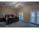Spacious main bedroom with plush carpeting and access to a balcony at 16600 Cleveland Ln, Umatilla, FL 32784