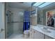 Bathroom features a walk-in shower and updated vanity at 16600 Cleveland Ln, Umatilla, FL 32784