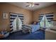 Bedroom with blue and white striped bedding and access to a balcony at 16600 Cleveland Ln, Umatilla, FL 32784