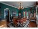 Elegant dining room with hardwood floors, chandelier, and antique furniture at 16600 Cleveland Ln, Umatilla, FL 32784