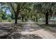 Long driveway lined with oak trees and Spanish moss at 16600 Cleveland Ln, Umatilla, FL 32784