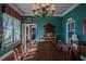 Sunlit dining room with hardwood floors, antique furniture, and a chandelier at 16600 Cleveland Ln, Umatilla, FL 32784