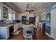 Bright kitchen featuring white cabinets, stainless steel appliances, and hardwood floors at 16600 Cleveland Ln, Umatilla, FL 32784
