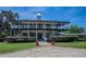 Two-story house with wrap-around porch and manicured lawn at 16600 Cleveland Ln, Umatilla, FL 32784