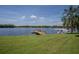 Serene lakefront view with a private dock and seaplane at 16600 Cleveland Ln, Umatilla, FL 32784