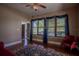 Spacious living room featuring hardwood floors, a fireplace, and ample natural light at 16600 Cleveland Ln, Umatilla, FL 32784