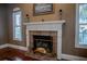 Brick fireplace with a white mantel and brass fireplace tools at 16600 Cleveland Ln, Umatilla, FL 32784