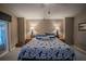 Spacious main bedroom with a king-size bed and access to the backyard at 16600 Cleveland Ln, Umatilla, FL 32784