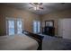 Main bedroom with a dresser and doors leading to a balcony at 16600 Cleveland Ln, Umatilla, FL 32784