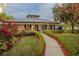 Single story home with walkway, landscaping and lake view at 16600 Cleveland Ln, Umatilla, FL 32784