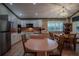 Kitchen with white cabinets, pink countertops, and breakfast nook at 16600 Cleveland Ln, Umatilla, FL 32784