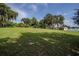 Peaceful lakeside lot with mature trees and a small shed at 16600 Cleveland Ln, Umatilla, FL 32784