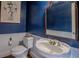 Stylish bathroom with pedestal sink, toilet, and ornate mirror at 16600 Cleveland Ln, Umatilla, FL 32784
