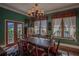 Formal dining room featuring hardwood floors, large windows, and a chandelier at 16600 Cleveland Ln, Umatilla, FL 32784