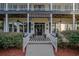 Charming front porch with rocking chairs and striped rug at 16600 Cleveland Ln, Umatilla, FL 32784