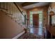 Bright entryway with hardwood floors and a grand staircase at 16600 Cleveland Ln, Umatilla, FL 32784