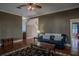 Living room with hardwood floors, a black leather couch, and a coffee table at 16600 Cleveland Ln, Umatilla, FL 32784