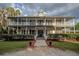 Two-story house with wrap around porch, and manicured landscaping at 16600 Cleveland Ln, Umatilla, FL 32784