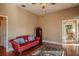Living room with hardwood floors, red couch, and access to other rooms at 16600 Cleveland Ln, Umatilla, FL 32784